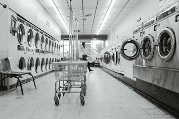 A laundromat with aisles of washing machines.