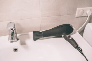 Black hair dryer on sink