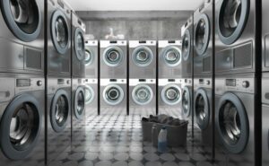 Rows of washers and dryers in empty laundromat